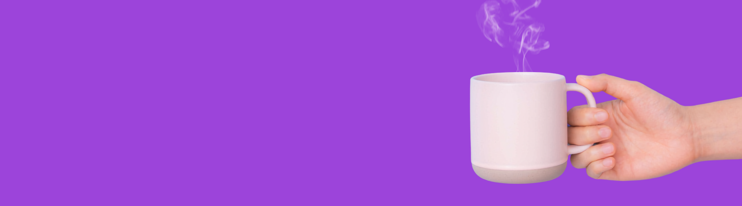 Hand holding cup of coffee on purple background
