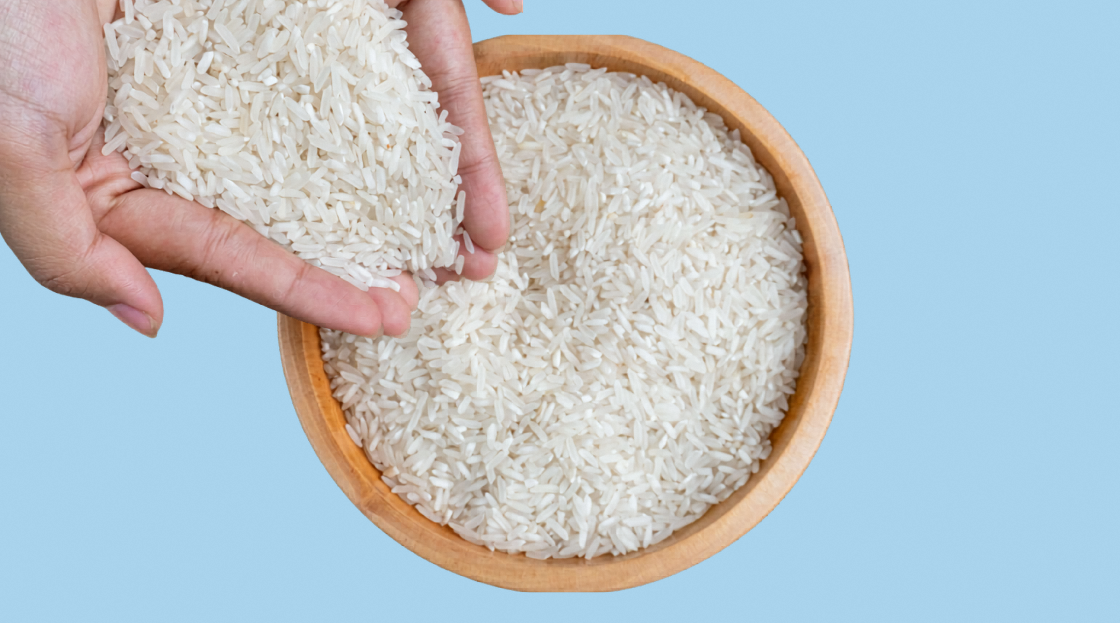 Top view hand pouring rice into bowl